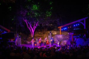 Evening concert with colorful spotlights on the performers at Lime Kiln Theater in Lexington VA.