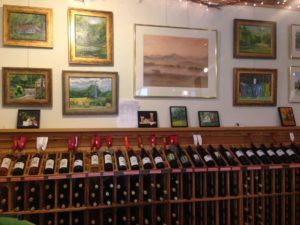 Wooden wine rack with hundreds of bottles of wine in the tasting room at Rockbridge Vineyard