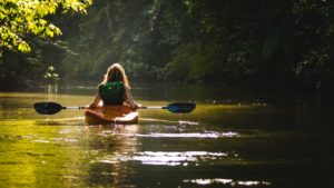 Woman kayaking in a calm river 