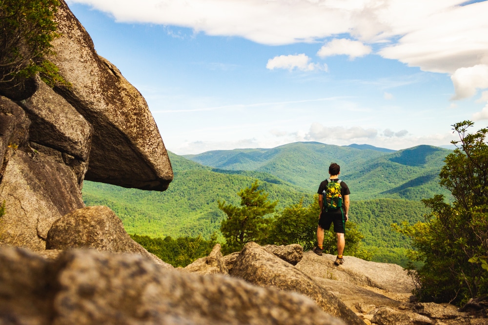 A man hiking in Shenandoah National Park, one of the best outdoor activities in Virginia