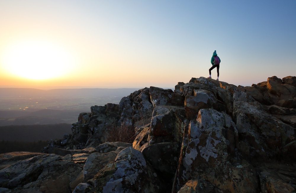A woman hiking at sunrise - one of the best things to do in Shenandoah National Park