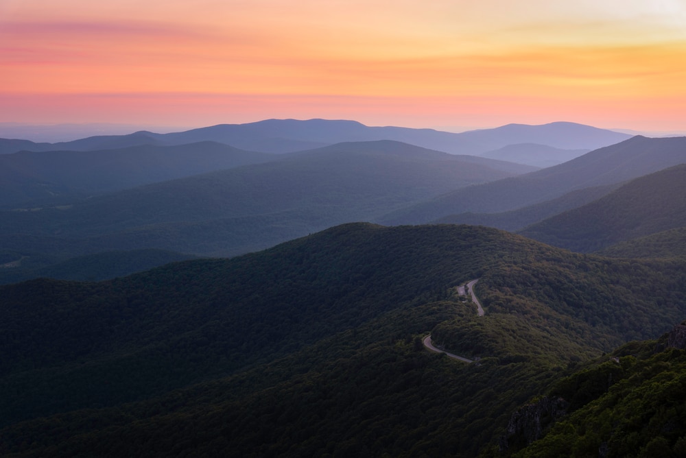 A gorgeous sunrise over Skyline Drive during the summer, one of the best times to visit Shenandoah Valley