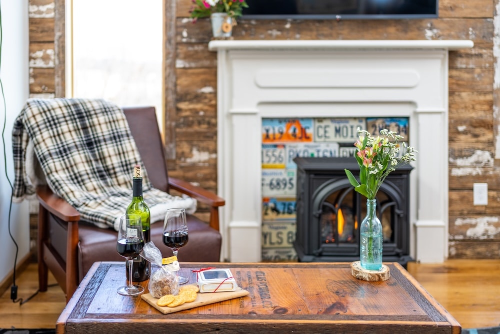 Glass of wine and cheese board in front of the fire in our romantic cabins in Virginia